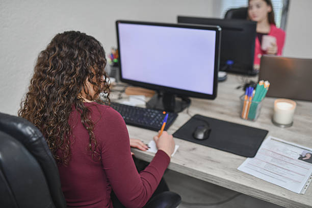 istock Motivated Beautiful Woman Working At Desk With Computer, Notepad, And Documents In Modern Office 2250165353