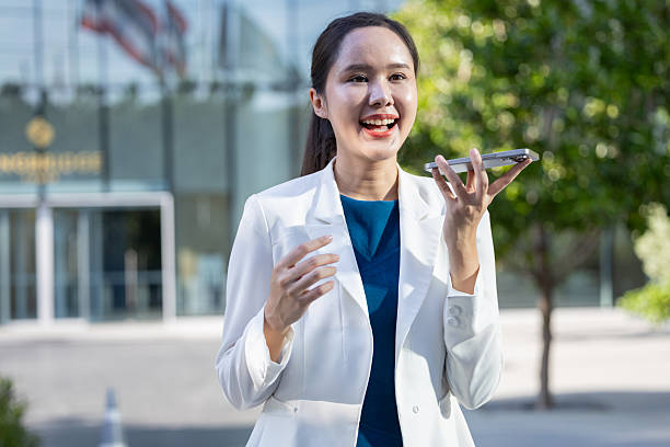Businesswoman using voice command on smartphone