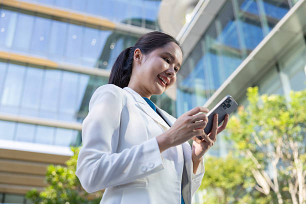 Businesswoman using voice command on smartphone