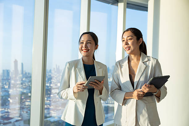 istock Businesswomen discussing ideas with digital tablets 2250165896