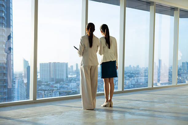 istock Businesswomen viewing cityscape from office window 2250165995