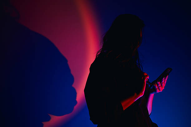 Silhouette of a woman in a position of overcoming, strength and power. Half tone. Copy space.
