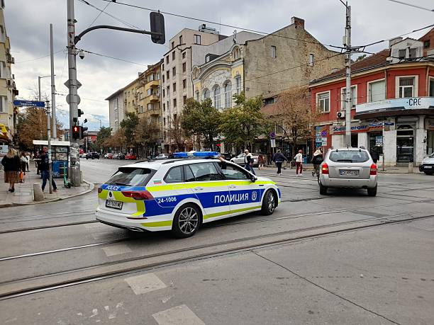 Sofia, Bulgaria - September 26 2025: Sofia City In Republic Of Bulgaria, Balkans, Southeast Europe, Bulgarian Police Officer With Land Vehicle, Building Exterior, Road Traffic, Tree, Retail Store, People Walking Scene And More During Autumn Season