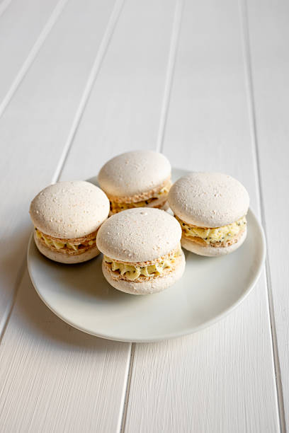 istock Four gourmet vanilla macarons with cream filling on plate 2250167774