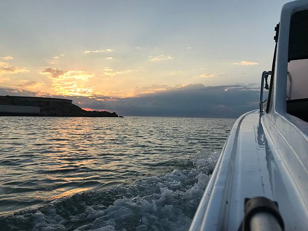 istock boat setting sail at sunrise 2250169453