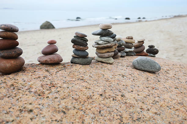 istock Calm beach sculpture, Peaceful cairns creating tranquil seaside meditation scene, Harmonious stone arrangements on beach evoke relaxation and exploratory leisure activities 2250173907