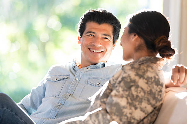 Couple happily conversing indoors with natural light streaming through the window