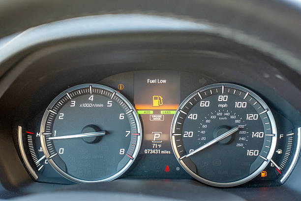 istock Car dashboard with fuel low warning and illuminated indicators 2250175562