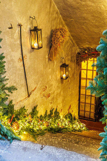 istock Festive Christmas decoration with lanterns and lights on a rough stone wall 2250177642
