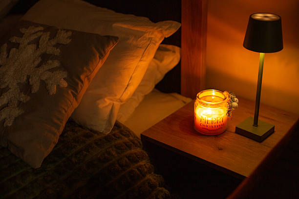 istock Cozy christmas candle burning on bedside table 2250180015