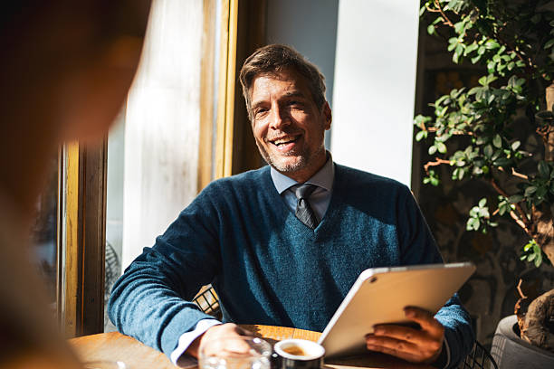 istock Smiling man having business meeting holding digital tablet 2250182348
