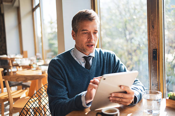 istock Businessman working on digital tablet in cafe 2250182816