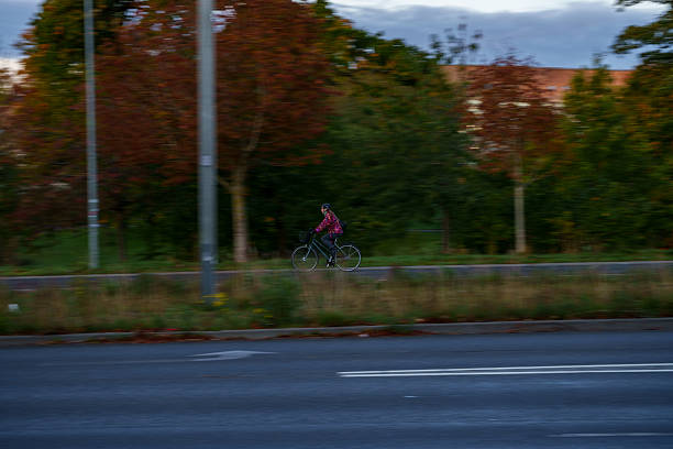 Cyclist on Rural Road at Sunset - Motion Blur Evening Commute