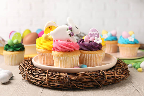 istock Tasty decorated Easter cupcakes on wooden table 2250188168