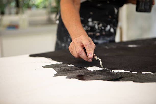 istock Mature female artist working in her studio 2250189220