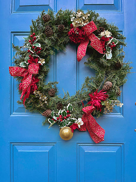istock Festive Christmas Wreath on a Bright Blue Door 2250192027