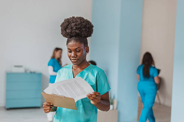 istock Medical workers in a hospital setting review documents during a shift change or team meeting with various tasks at hand 2250194822