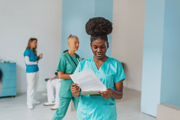 istock Medical workers perform tasks in a hospital setting while reviewing patient information and discussing care plans 2250194929