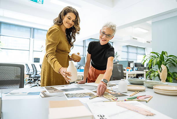 istock Two mature creative entrepreneurs working in creative office with pottery and interior design solutions 2250195061