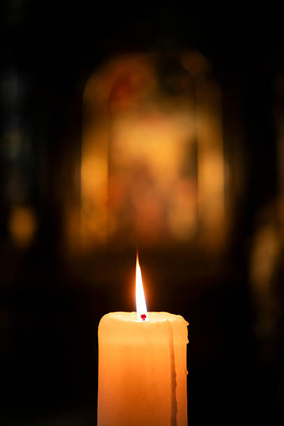 istock Single Burning Candle in Church 2250196466