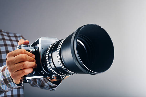 High-quality vintage SLR film photo camera isolated on white background. Silver and black plastic color.