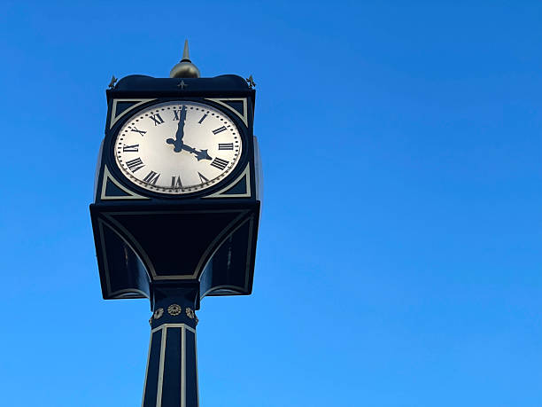 istock A clock tower stands against a clear blue sky 2250199240