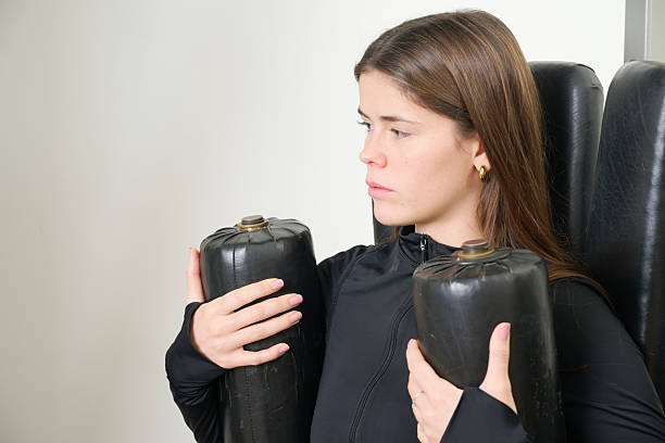 Woman performing a strength workout on a fitness machine, engaging core muscles with a determined expression