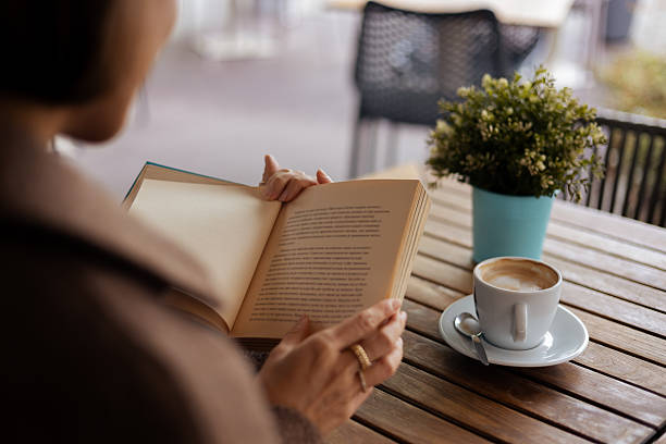 Man reading a novel while relaxing with coffee