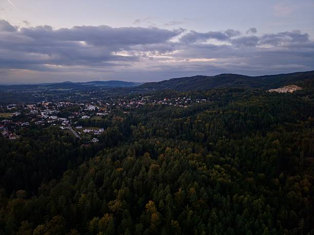 istock Sunset Hill View, Serene Vantage Point Revealing Distant Settlement Nestled Within Forested Landscape 2250208553