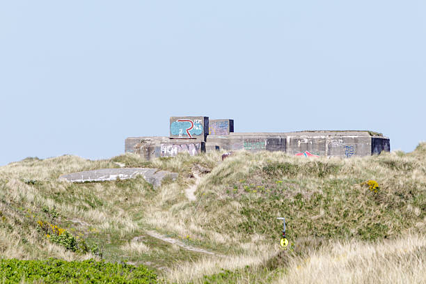 A massive World War II bunker standing prominently along the North Sea coast in Denmark. Once part of the German Atlantic Wall, the concrete structure now contrasts with the surrounding beach, 1941 - 1945