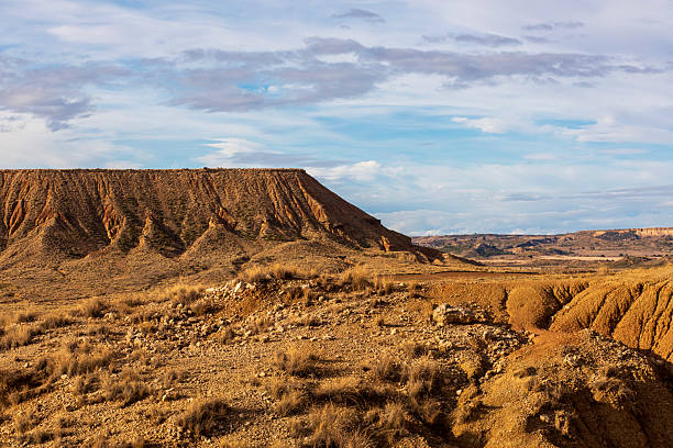 istock Majestic landscape with layered cliffs and vast desert under a dramatic sky 2250214464