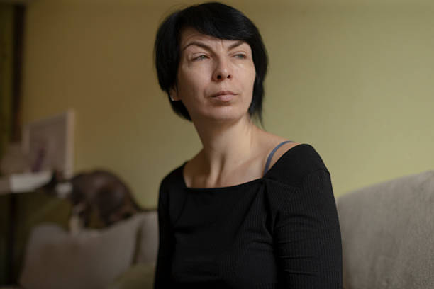 istock female pondering indoors, woman with reflective expression inside 2250216689