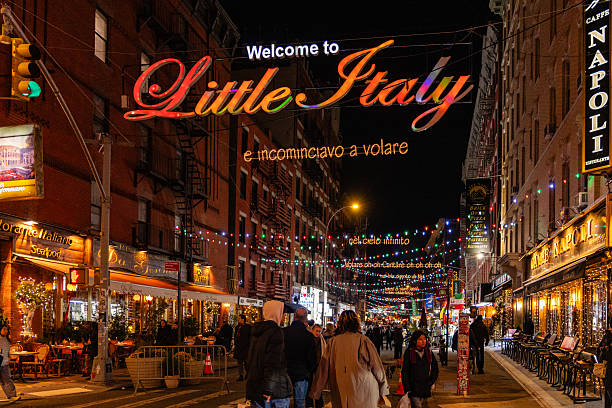 New York, NY, US-December 1, 2025: Street in the historic Little Italy neighborhood at night decorated for the Christmas holidays with people walking in the streets.