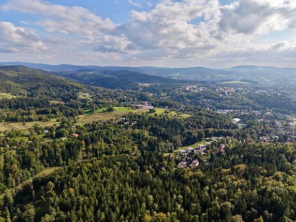 istock Scene Depicting Natural Greenery Transitioning Into Urban Development Beneath Layered Cloud Formations 2250217208