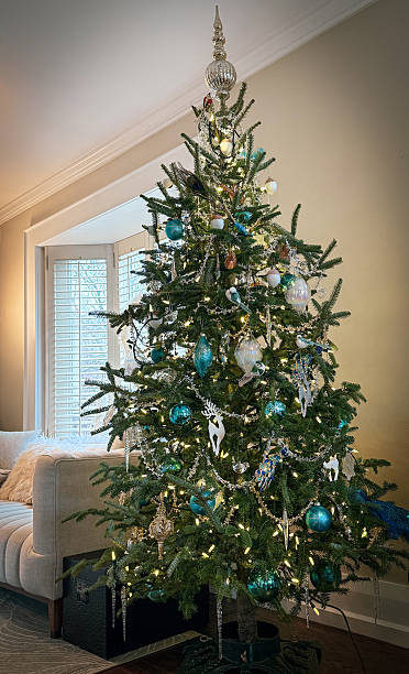 istock Natural Christmas Tree with Ornaments and Lights in Home Setting 2250217464