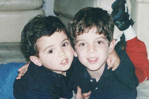 istock Image taken in 1980s: little male siblings embracing 2250219117