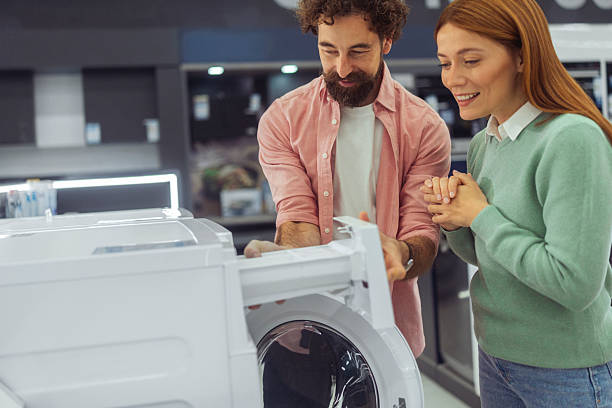 istock Happy Loving Couple Checking Washing Machine Detergent Dispenser 2250229003