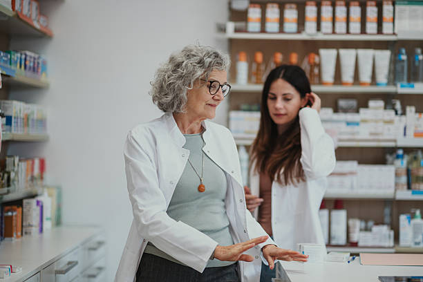 istock Mature pharmacist mentoring young trainee in pharmacy 2250234572