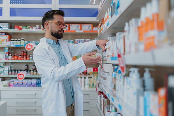 istock Male pharmacist working in modern pharmacy checking medication 2250234615