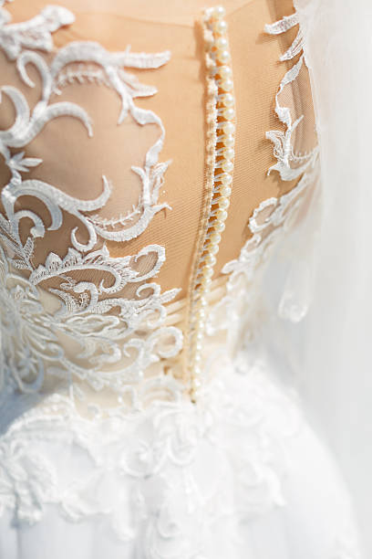 istock the bride holds in her hands a beautiful wedding dress 2250237457