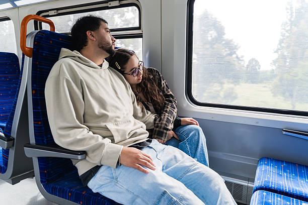 istock Tired Couple Resting Head on Shoulder on Train 2250237638