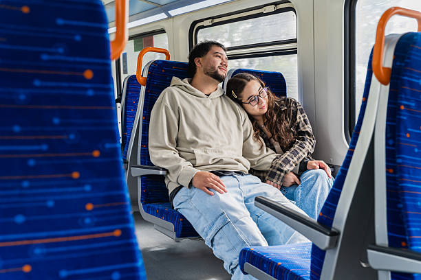 istock Tired Couple Resting Head on Shoulder on Train 2250237642