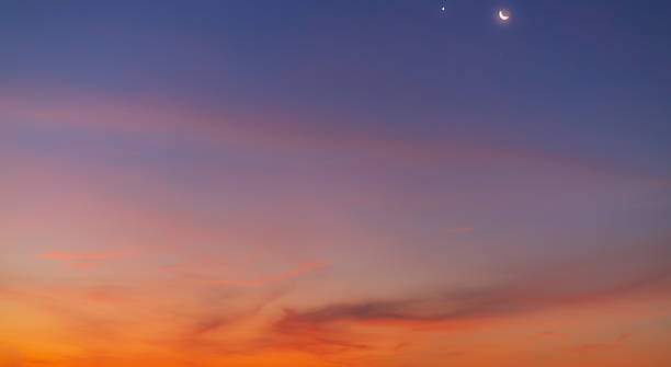 istock Colorful clouds and sky backdrop during twilight,sky and clouds during sunset time background,Twilight sky with crescent moon, soft pink clouds, and gradient colors during peaceful sunset. 2250253661