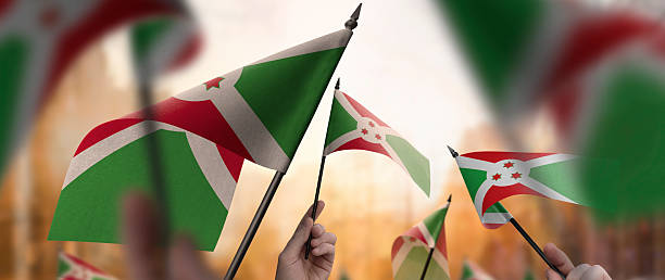 istock Burundi flags in their hands on a blurred urban background 2250255787