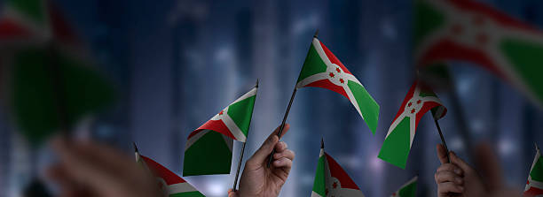 istock Burundi flags in their hands on a blurred urban background 2250255794