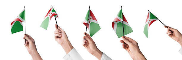 The Burundi flag in hand in different angles on a white background.
