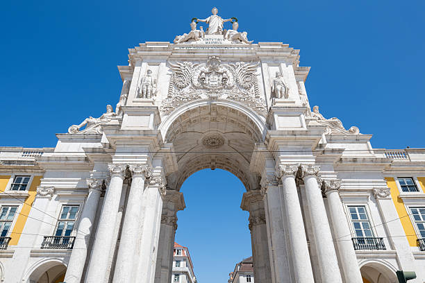 Lisbon, Portugal - May 4, 2025. Tourists walking in front of the Rua Augusta Arch at Commerce Square in Lisbon, Portugal