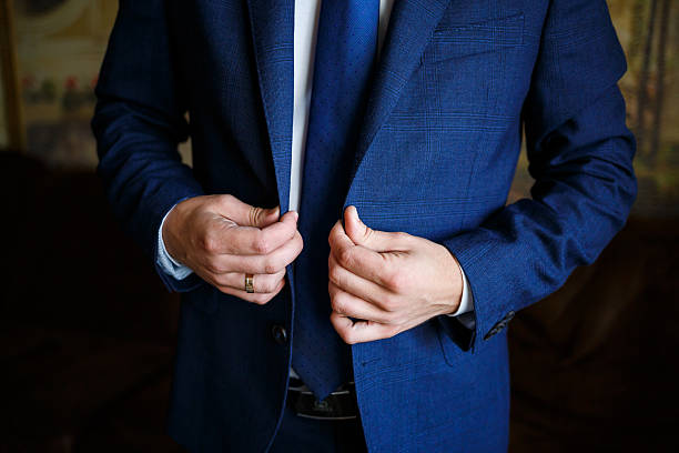 istock man puts on a suit on the wedding day 2250264046