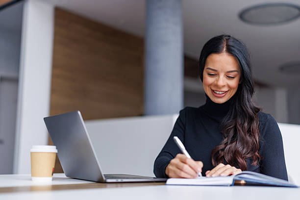 istock Professional woman writing notes during business meeting 2250265667
