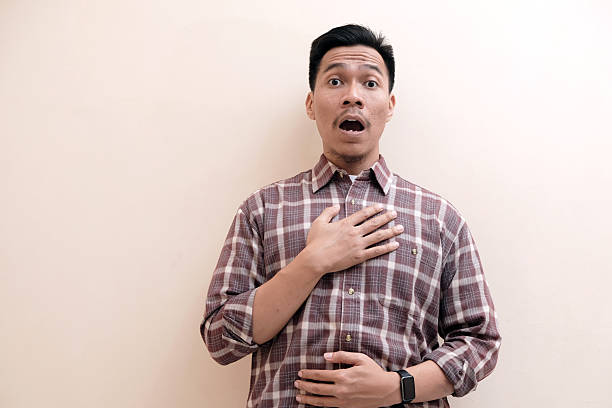 istock Southeast Asian man wearing flannel shirt showing shocked face expression 2250266149